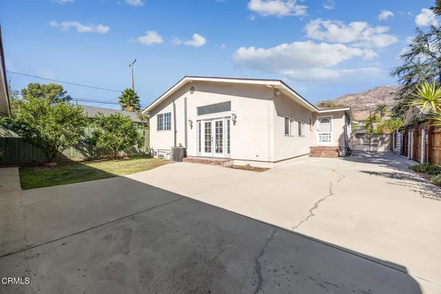 a yellow house with trees in front of it