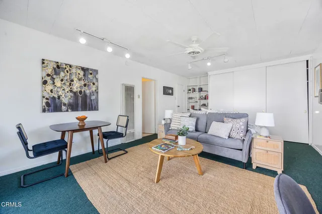 a living room with furniture a rug and a chandelier
