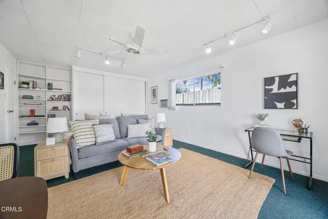 a living room with furniture and a rug