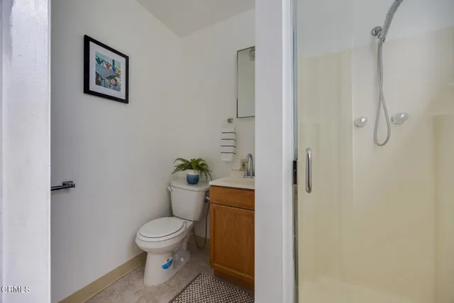 a white toilet sitting next to a bathroom sink