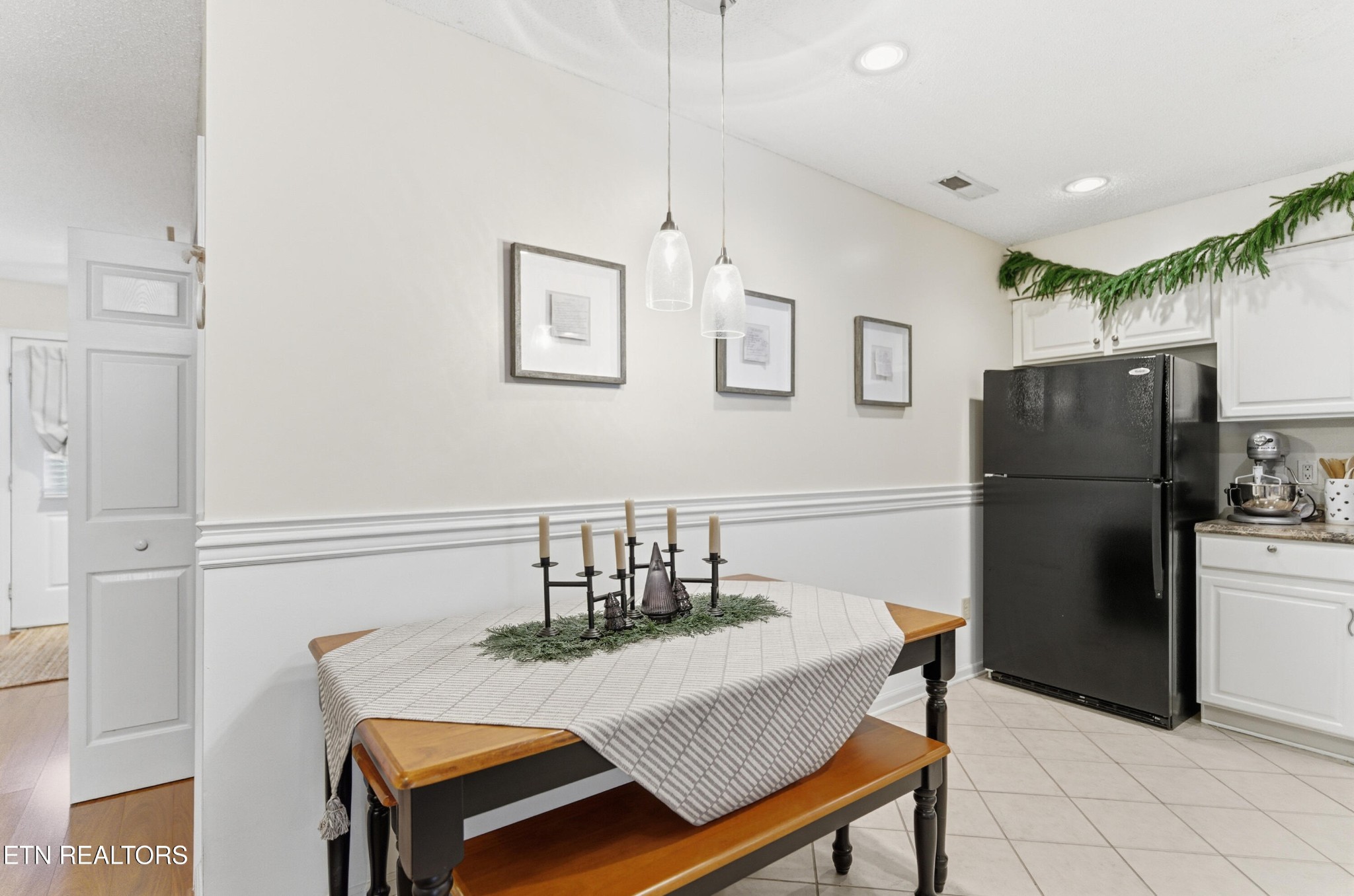 8009 Chambord Way Powell, TN 37849 - Photo 16 of 32 a kitchen with stainless steel appliances granite countertop a dining table chairs and refrigerator