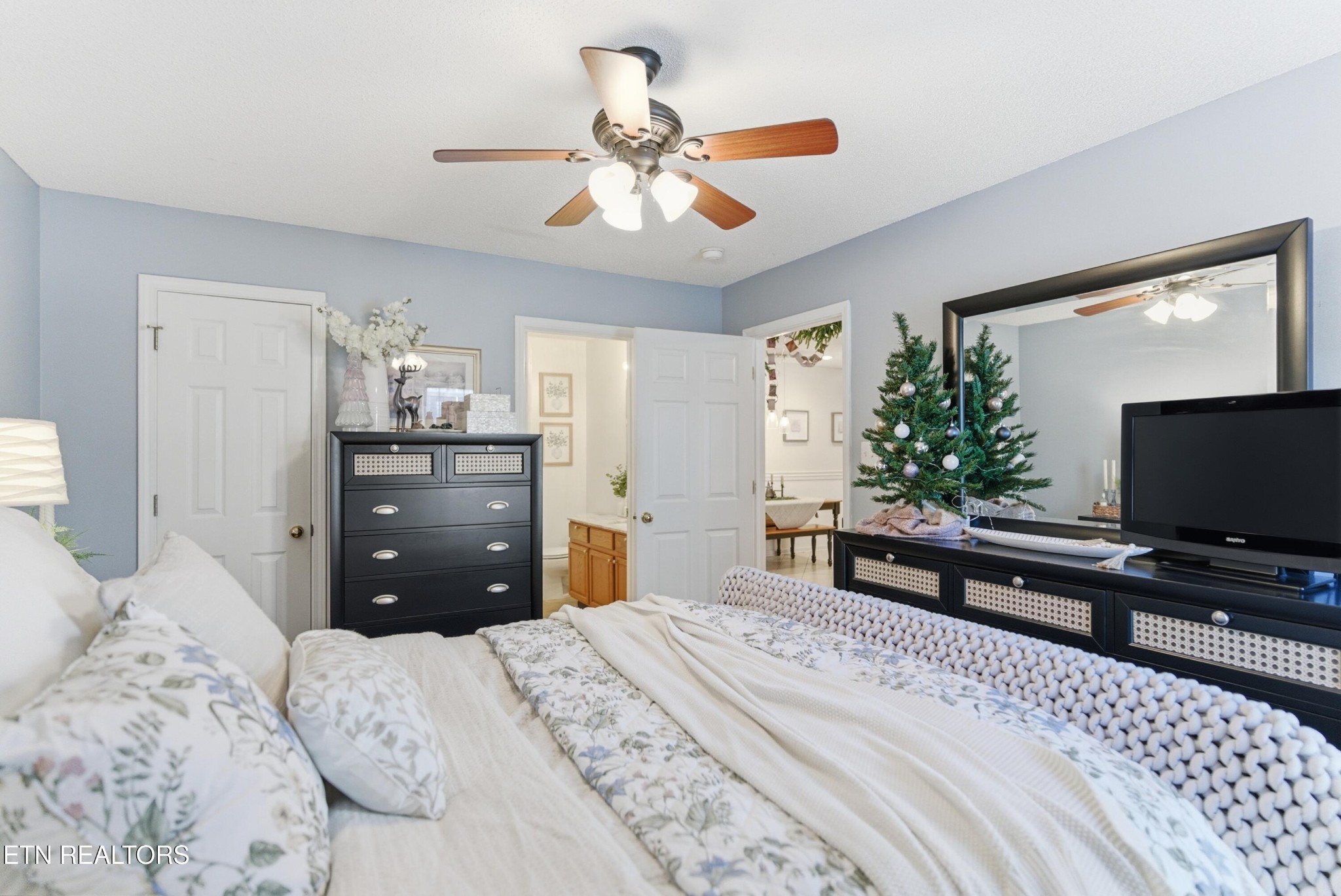 8009 Chambord Way Powell, TN 37849 - Photo 18 of 32 a bedroom with a bed and a flat screen tv