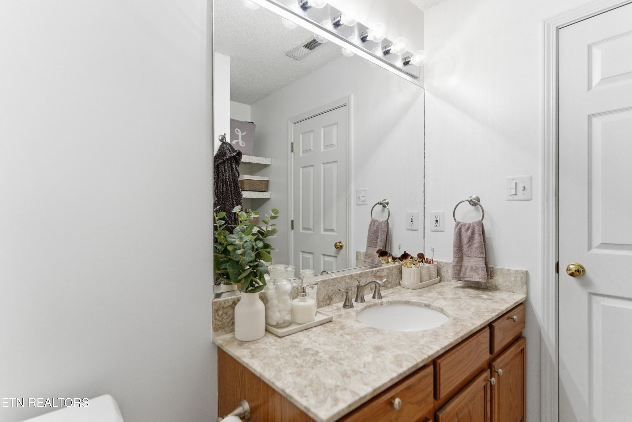 8009 Chambord Way Powell, TN 37849 - Photo 22 of 32 a bathroom with a granite countertop sink and a mirror