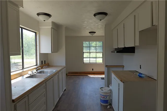 a kitchen with a refrigerator and a stove