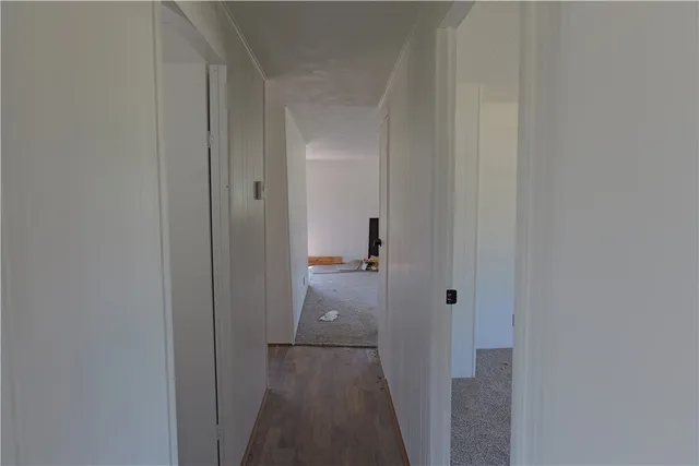 a view of a bathroom from the hallway with toilet