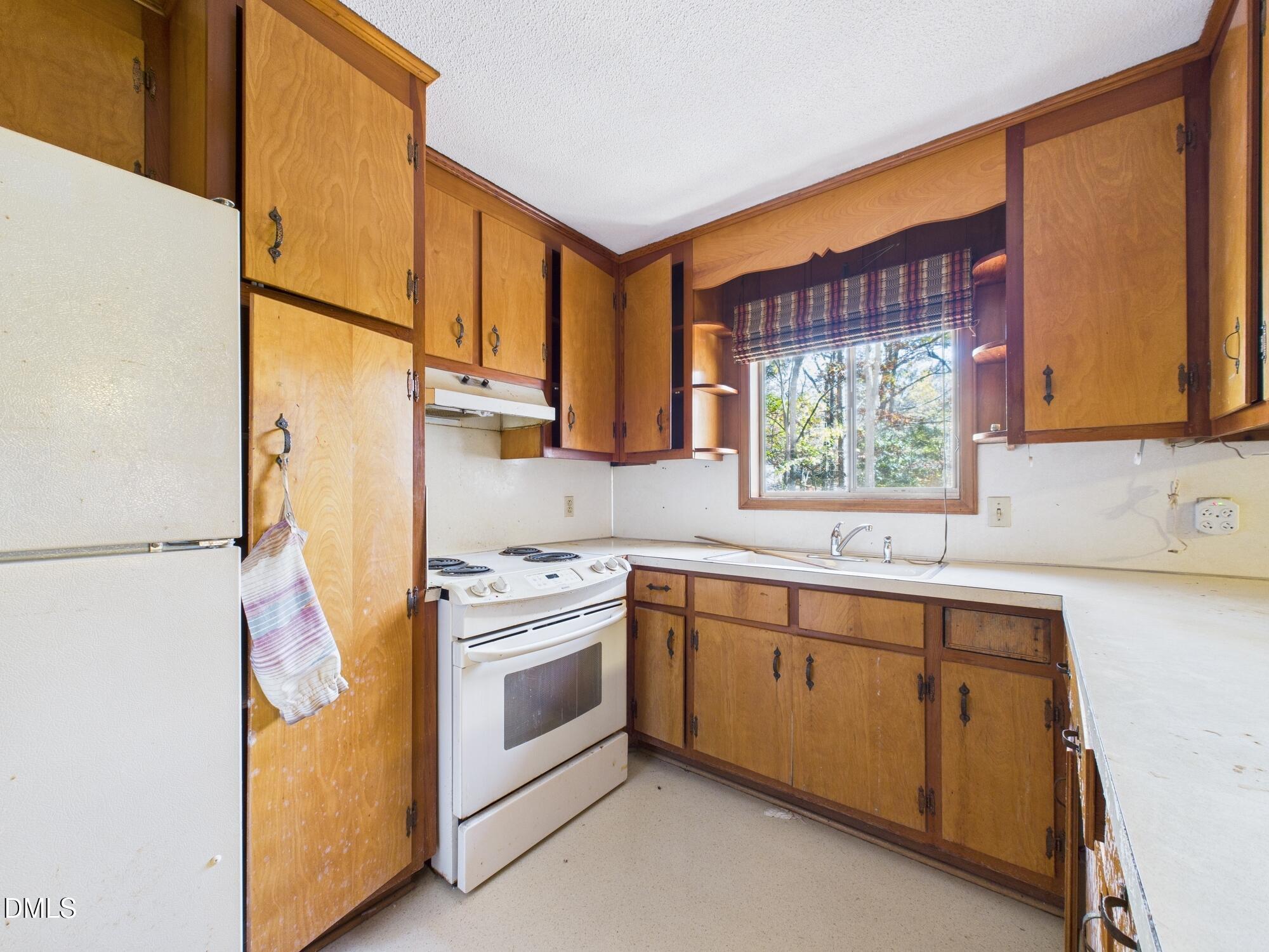 1012 Akron Avenue Durham, NC 27713 - Photo 11 of 43 a kitchen with appliances cabinets and a sink