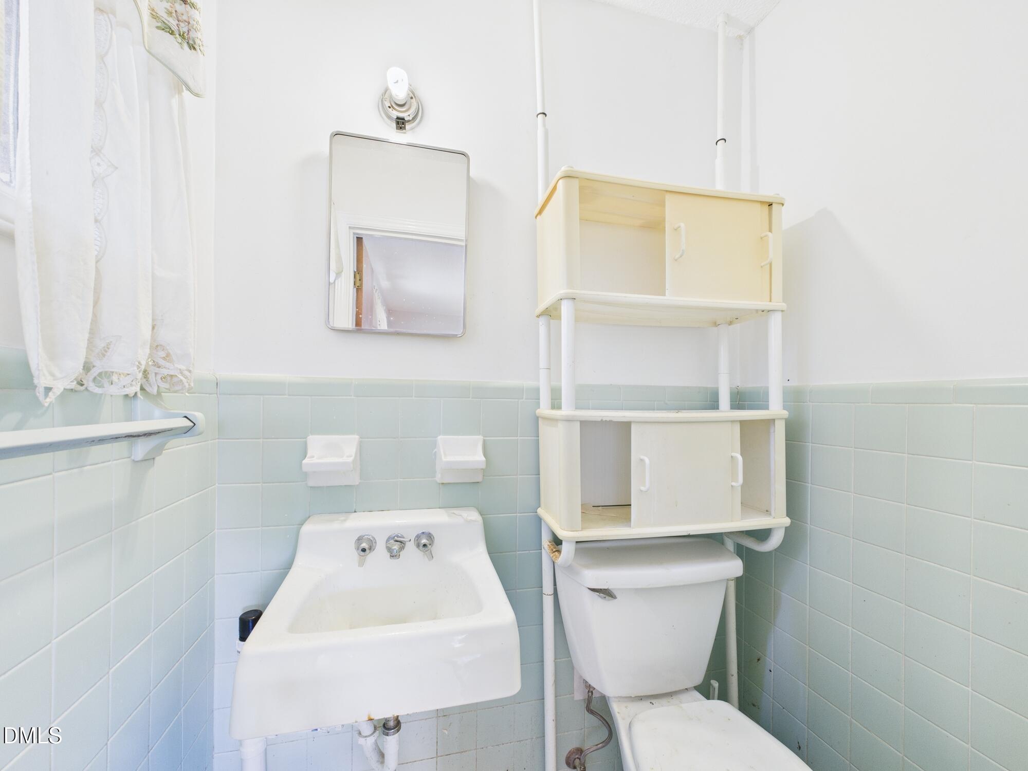 1012 Akron Avenue Durham, NC 27713 - Photo 17 of 43 a white toilet sitting next to a bathroom sink