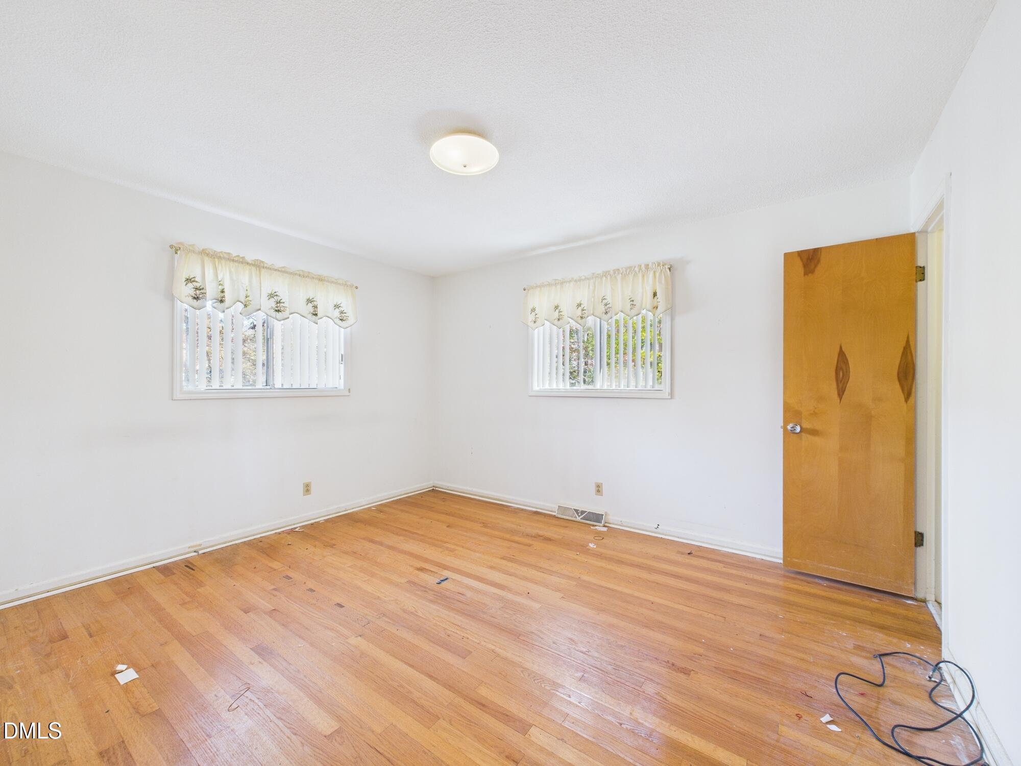 1012 Akron Avenue Durham, NC 27713 - Photo 19 of 43 a view of empty room with wooden floor and fan