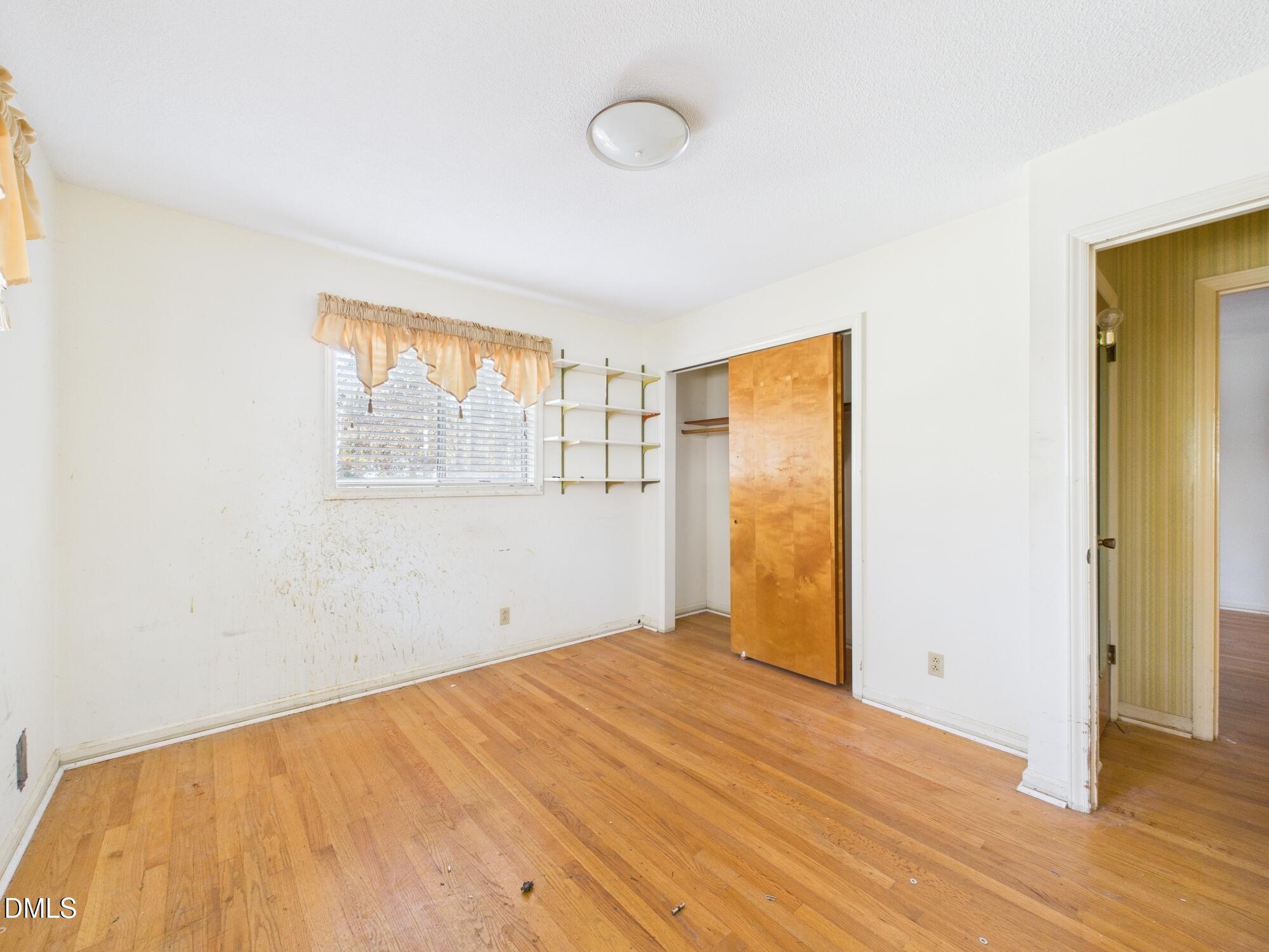 1012 Akron Avenue Durham, NC 27713 - Photo 22 of 43 a view of empty room with wooden floor and fan