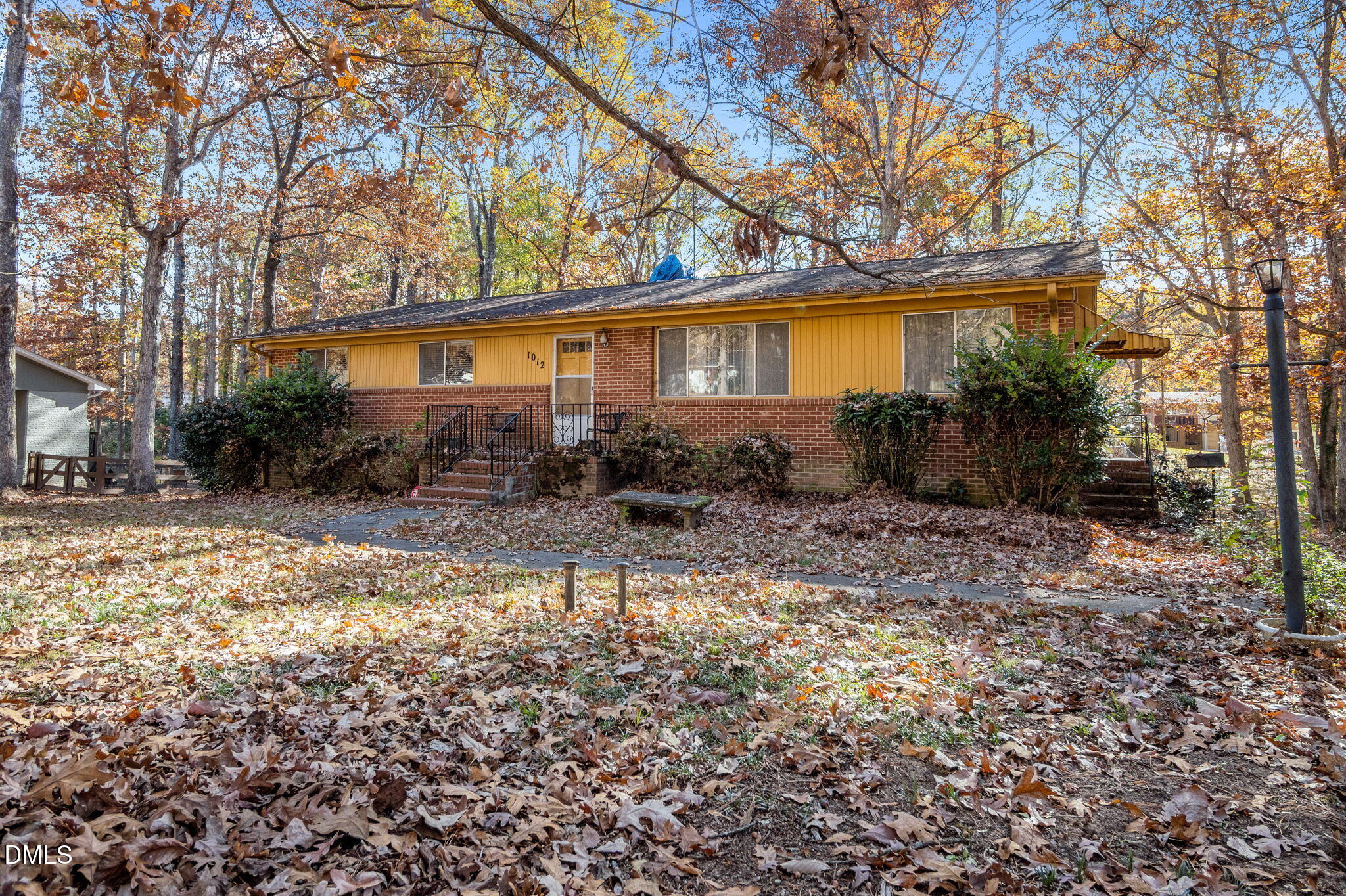 1012 Akron Avenue Durham, NC 27713 - Photo 3 of 43 a backyard of a house with table and chairs under an umbrella