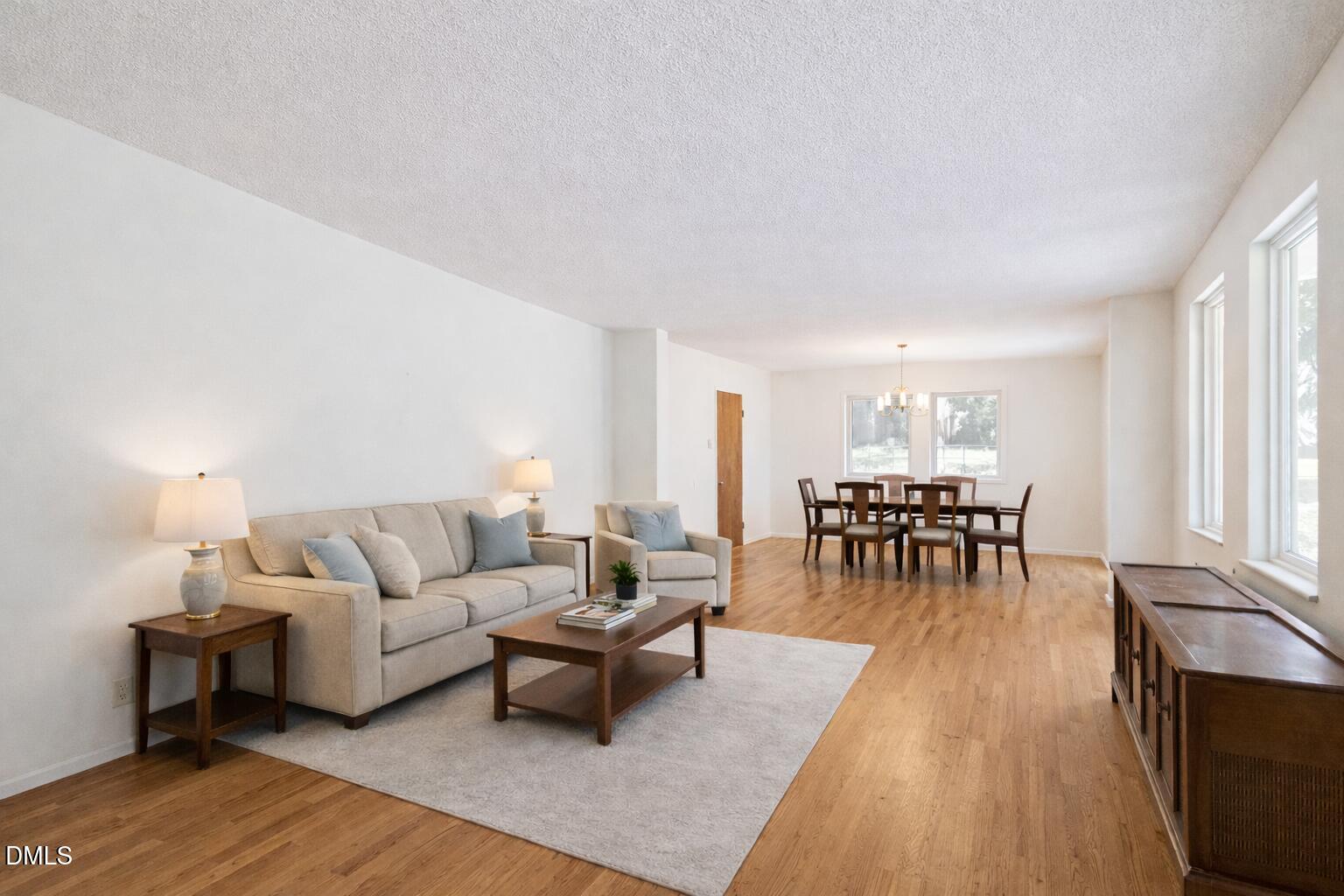 1012 Akron Avenue Durham, NC 27713 - Photo 7 of 43 a living room with furniture and a dining table with wooden floor