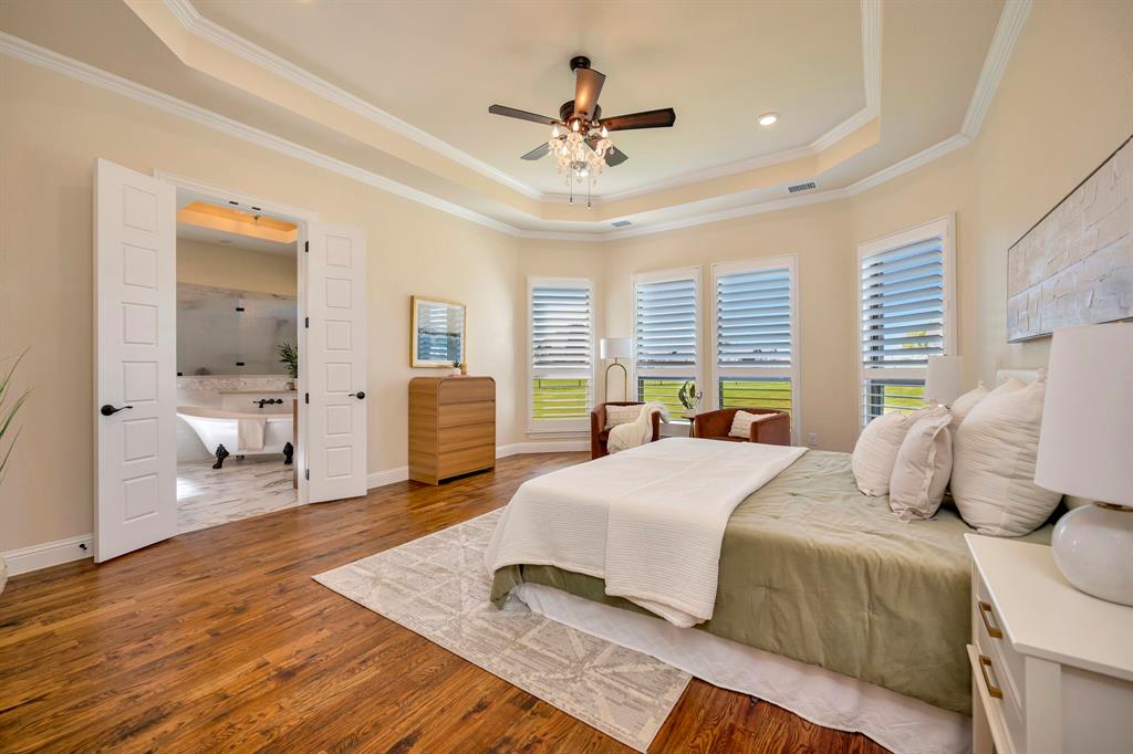 3800 Ridge Point Drive Northlake, TX 76226 - Photo 20 of 39 a bedroom with a large bed and a chandelier