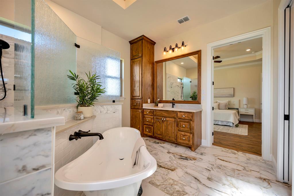 3800 Ridge Point Drive Northlake, TX 76226 - Photo 27 of 39 a bathroom with a tub sink and mirror