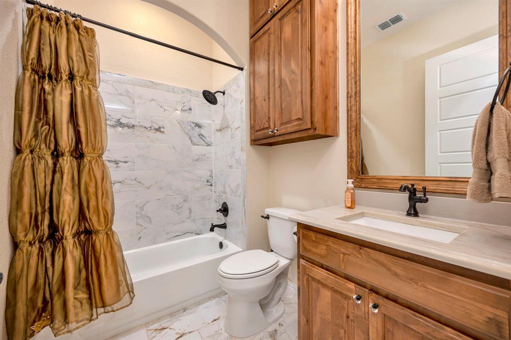 3800 Ridge Point Drive Northlake, TX 76226 - Photo 29 of 39 a bathroom with a sink a toilet and a bathtub