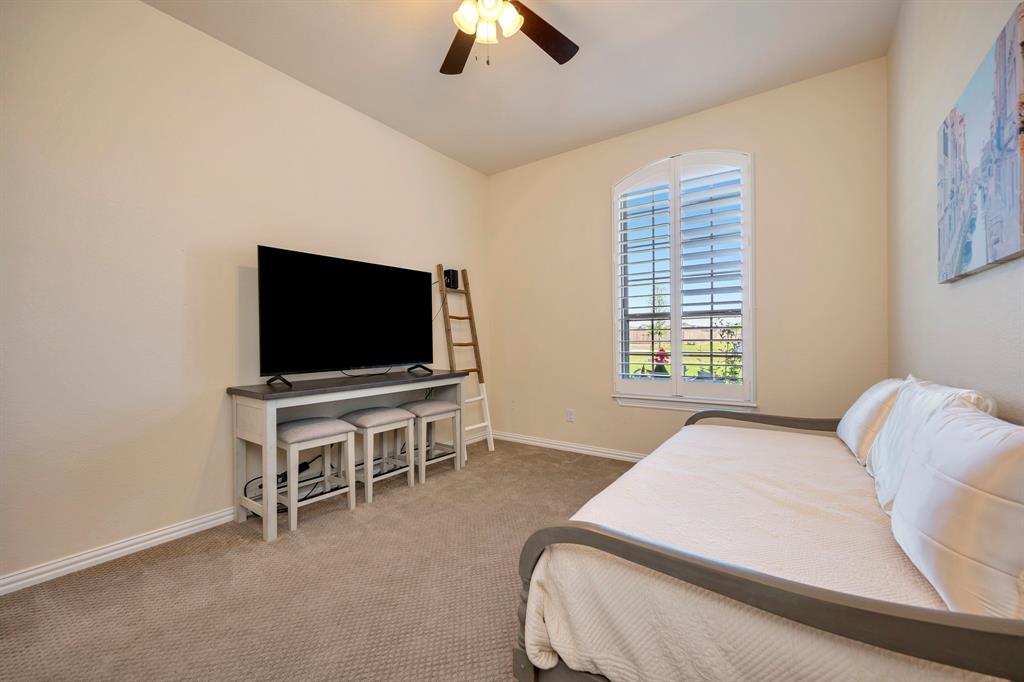 3800 Ridge Point Drive Northlake, TX 76226 - Photo 31 of 39 a bedroom with a bed and a flat screen tv