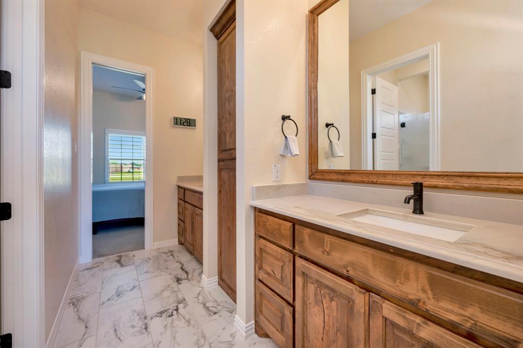 3800 Ridge Point Drive Northlake, TX 76226 - Photo 33 of 39 a bathroom with a granite countertop sink and a mirror