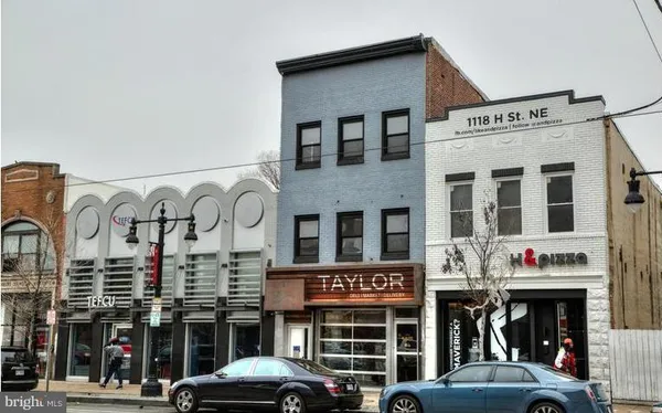 a front view of a building with parking