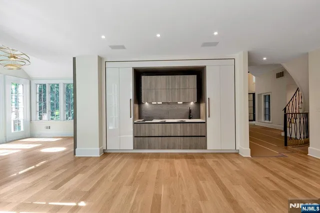 a view of an empty room with a fireplace and a window