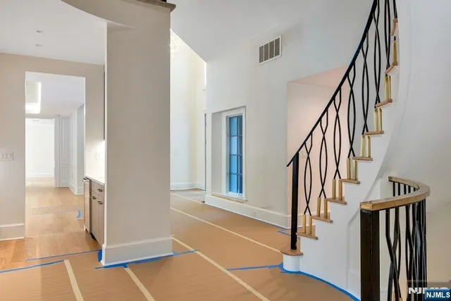an empty room with wooden floor and a fireplace
