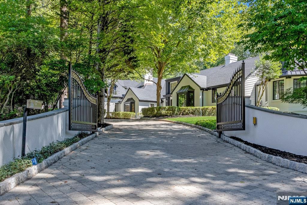 4 Duck Pond Road Alpine, NJ 07620 - Photo 2 of 35 a front view of a house with a garden and trees