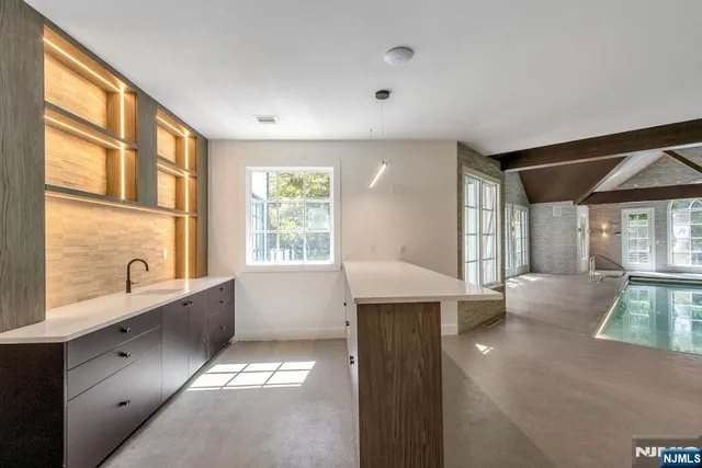 a bathroom with a shower a sink and mirror