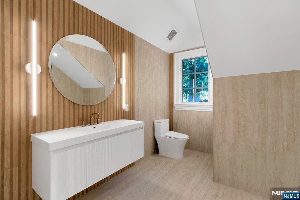 4 Duck Pond Road Alpine, NJ 07620 - Photo 24 of 35 a bathroom with a sink a toilet and a mirror