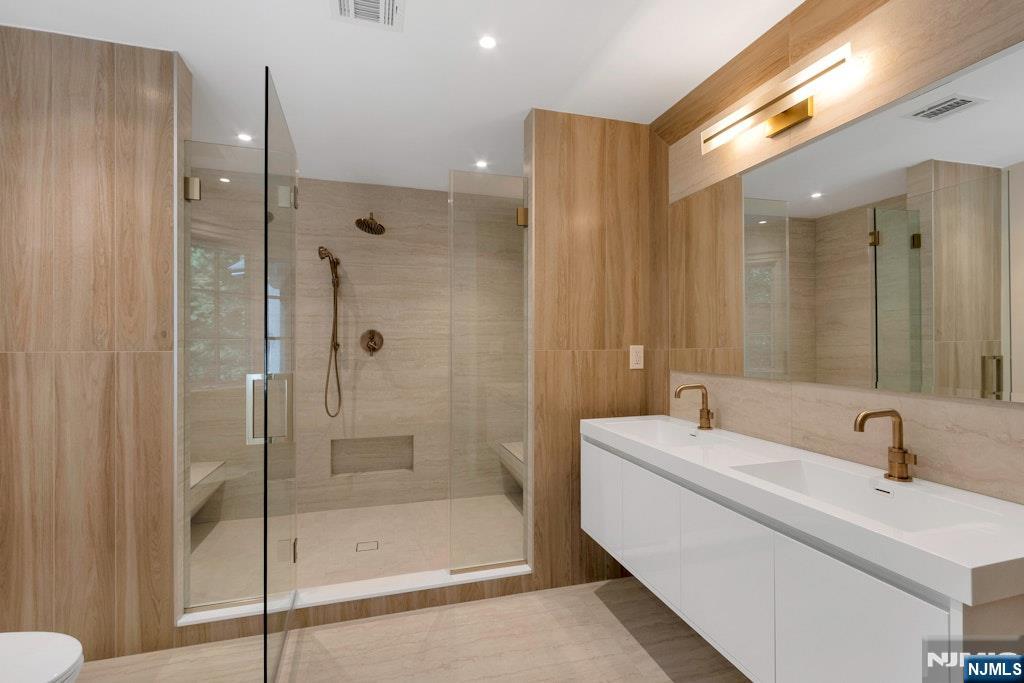 4 Duck Pond Road Alpine, NJ 07620 - Photo 31 of 35 a bathroom with a shower a sink and mirror