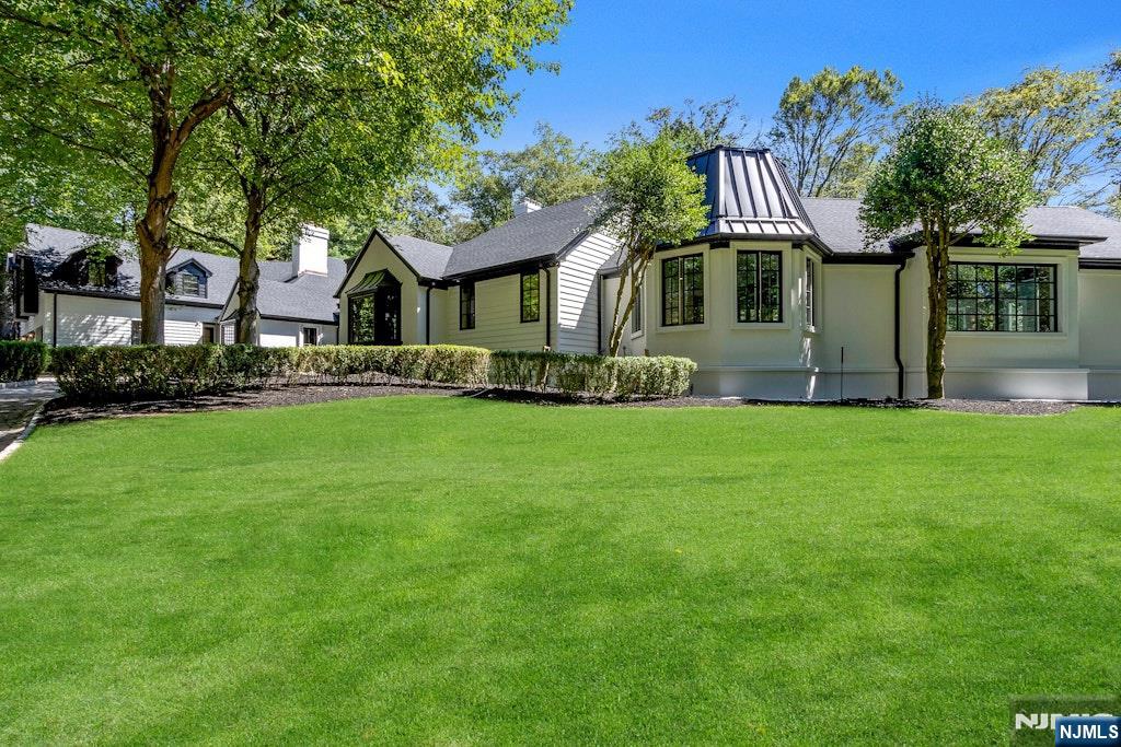 4 Duck Pond Road Alpine, NJ 07620 - Photo 35 of 35 a front view of a house with a garden and trees