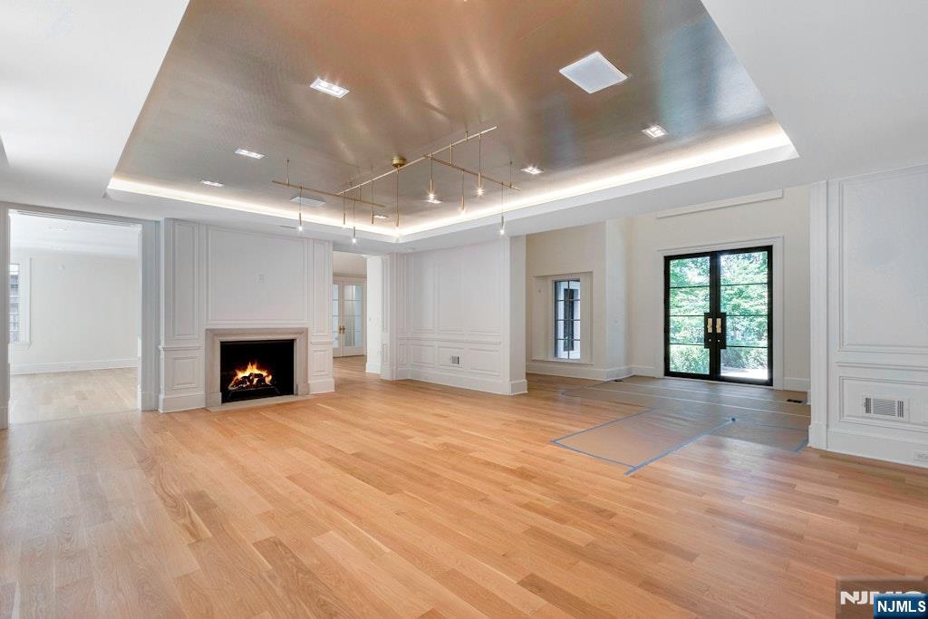 4 Duck Pond Road Alpine, NJ 07620 - Photo 4 of 35 a view of an empty room with a fireplace and a window