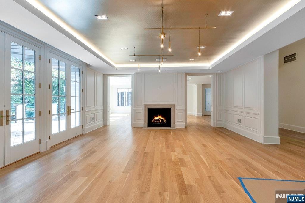 4 Duck Pond Road Alpine, NJ 07620 - Photo 5 of 35 a view of an empty room with wooden floor fireplace and a window