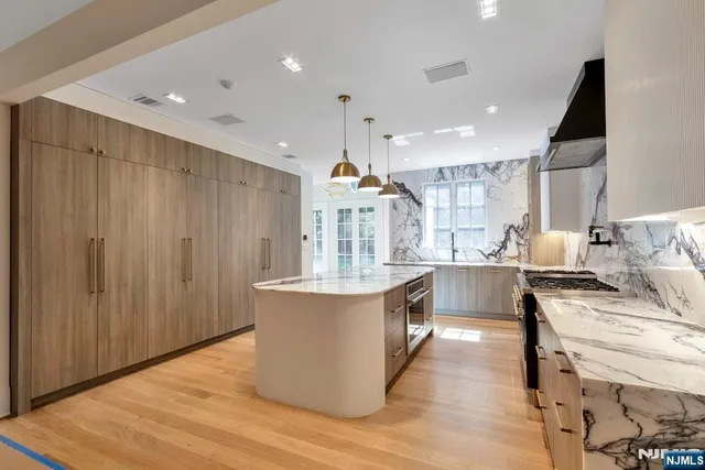 a kitchen with stainless steel appliances granite countertop a stove and a sink
