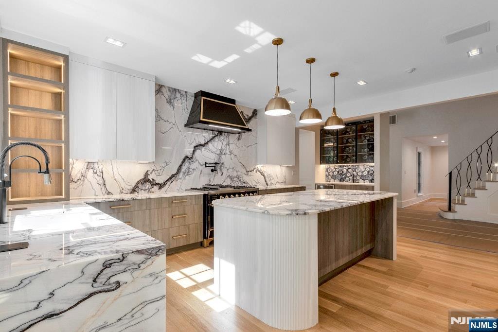 4 Duck Pond Road Alpine, NJ 07620 - Photo 9 of 35 a kitchen with stainless steel appliances granite countertop a stove and a sink