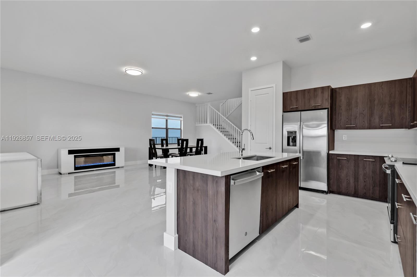 4276 Southwest 173rd Avenue Miramar, FL 33029 - Photo 13 of 58 a kitchen with stainless steel appliances a sink stove and refrigerator