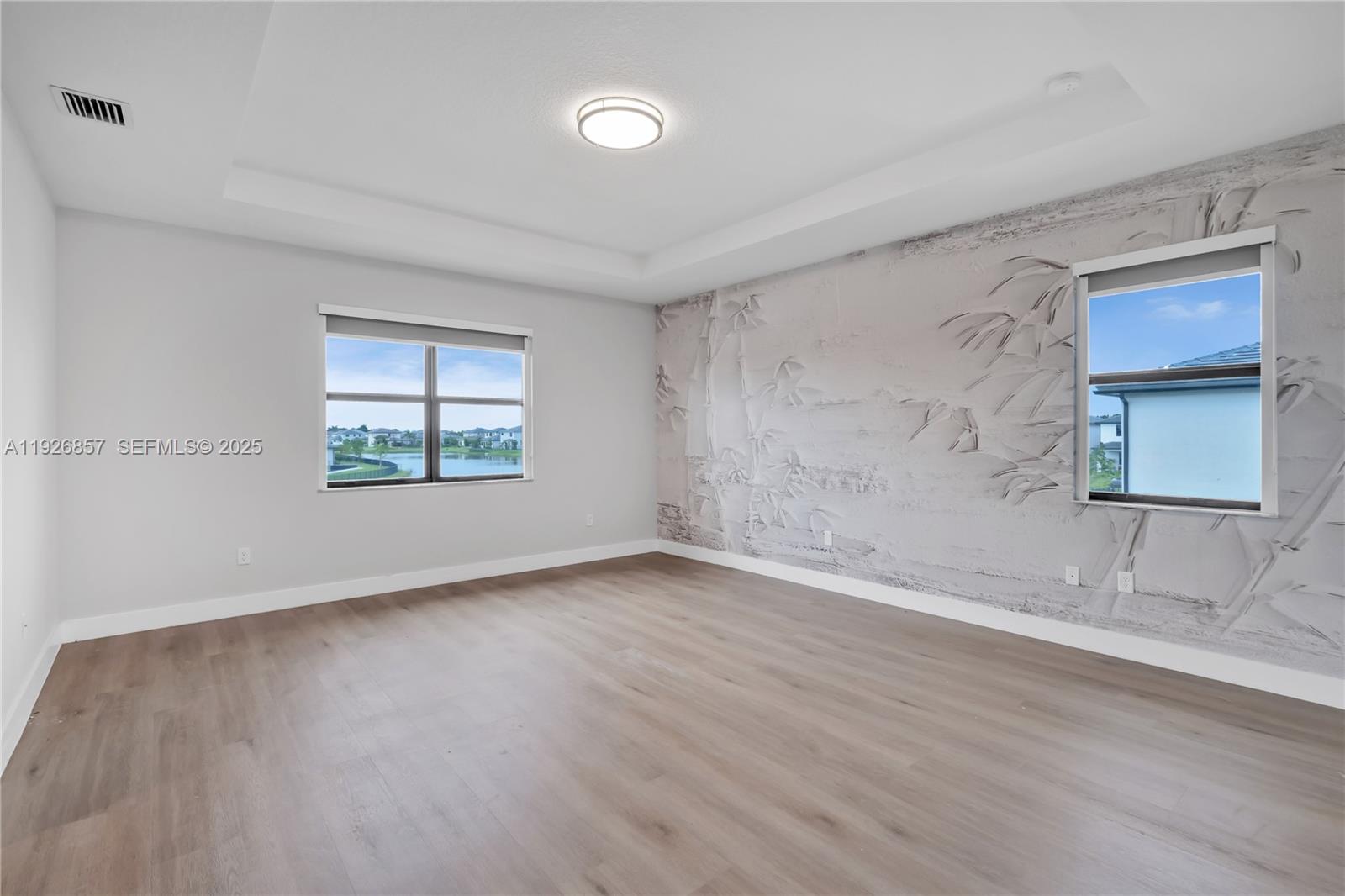 4276 Southwest 173rd Avenue Miramar, FL 33029 - Photo 32 of 58 an empty room with wooden floor and windows