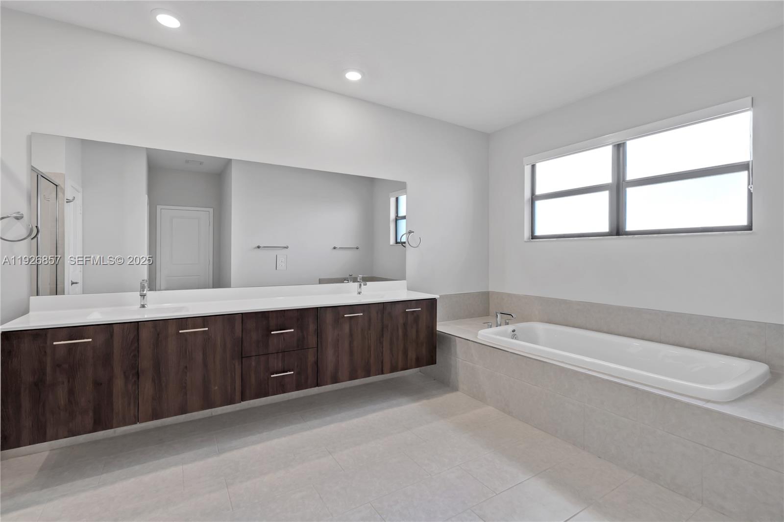4276 Southwest 173rd Avenue Miramar, FL 33029 - Photo 39 of 58 a spacious bathroom with a tub sink and mirror