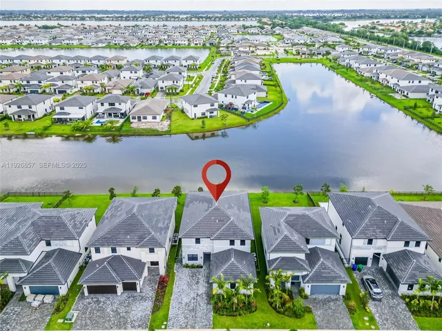 an aerial view of a house with a swimming pool yard and outdoor seating