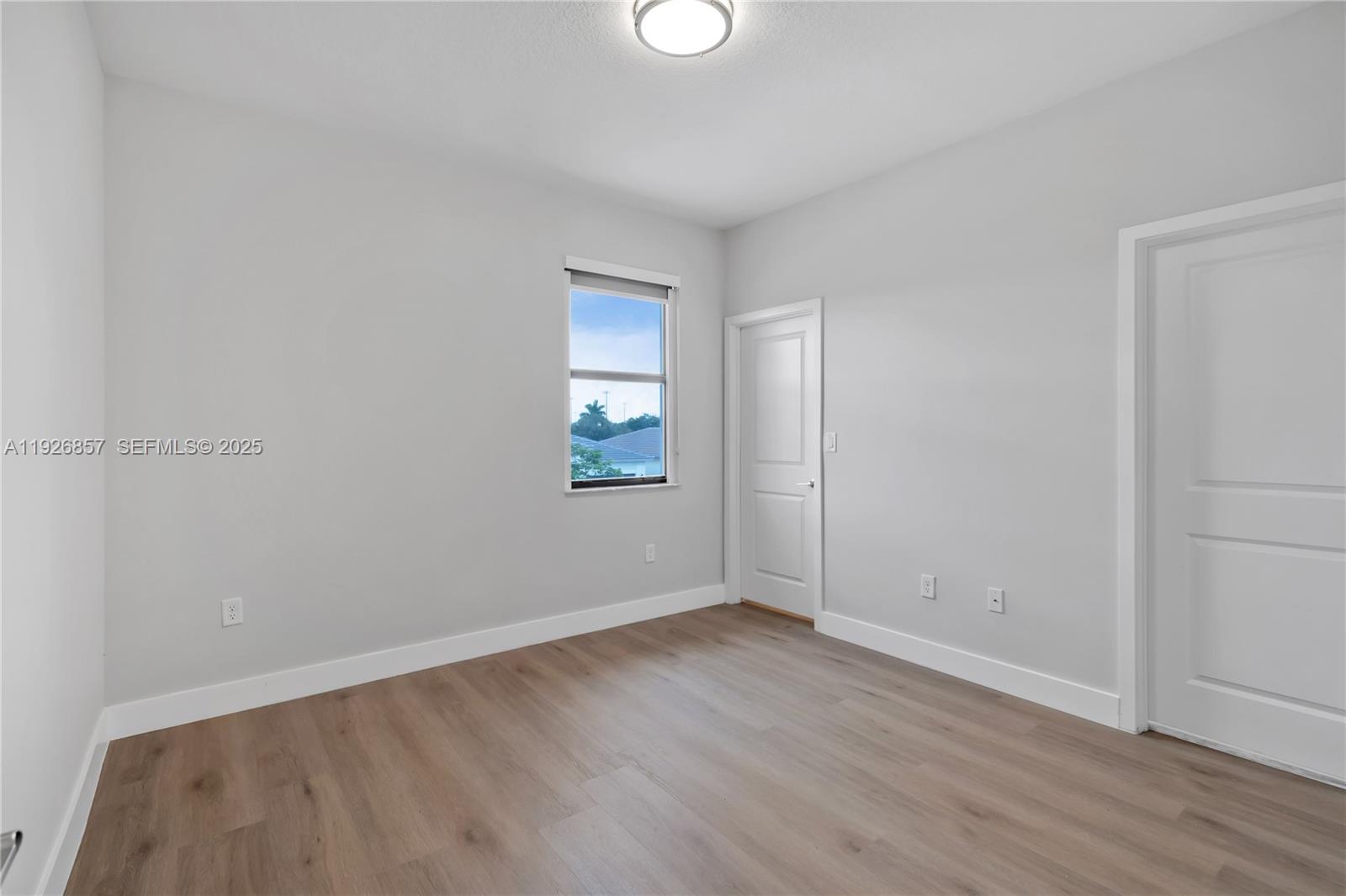 4276 Southwest 173rd Avenue Miramar, FL 33029 - Photo 49 of 58 an empty room with wooden floor and windows