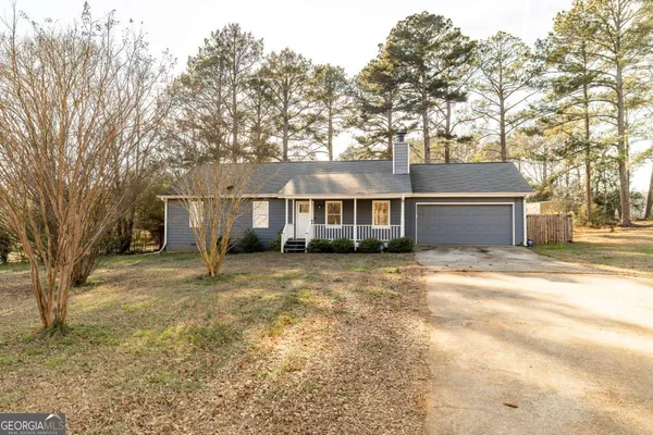 a view of a house with a yard and garage