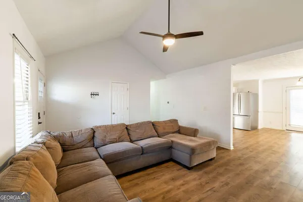 a living room with furniture and a chandelier