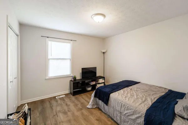 a bedroom with a bed and a window