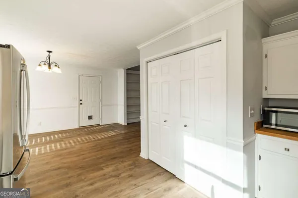 a view of empty room with wooden floor