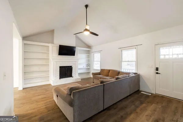 a living room with furniture and a fireplace