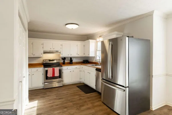 a kitchen with stainless steel appliances a refrigerator sink and microwave