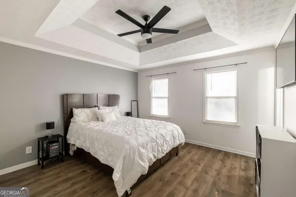 a bedroom with a bed and a large window