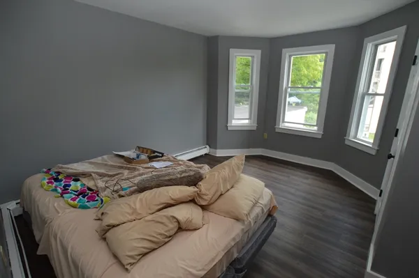 a bedroom with a bed and window