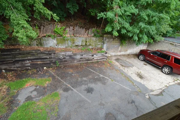 a view of a street with a car parked