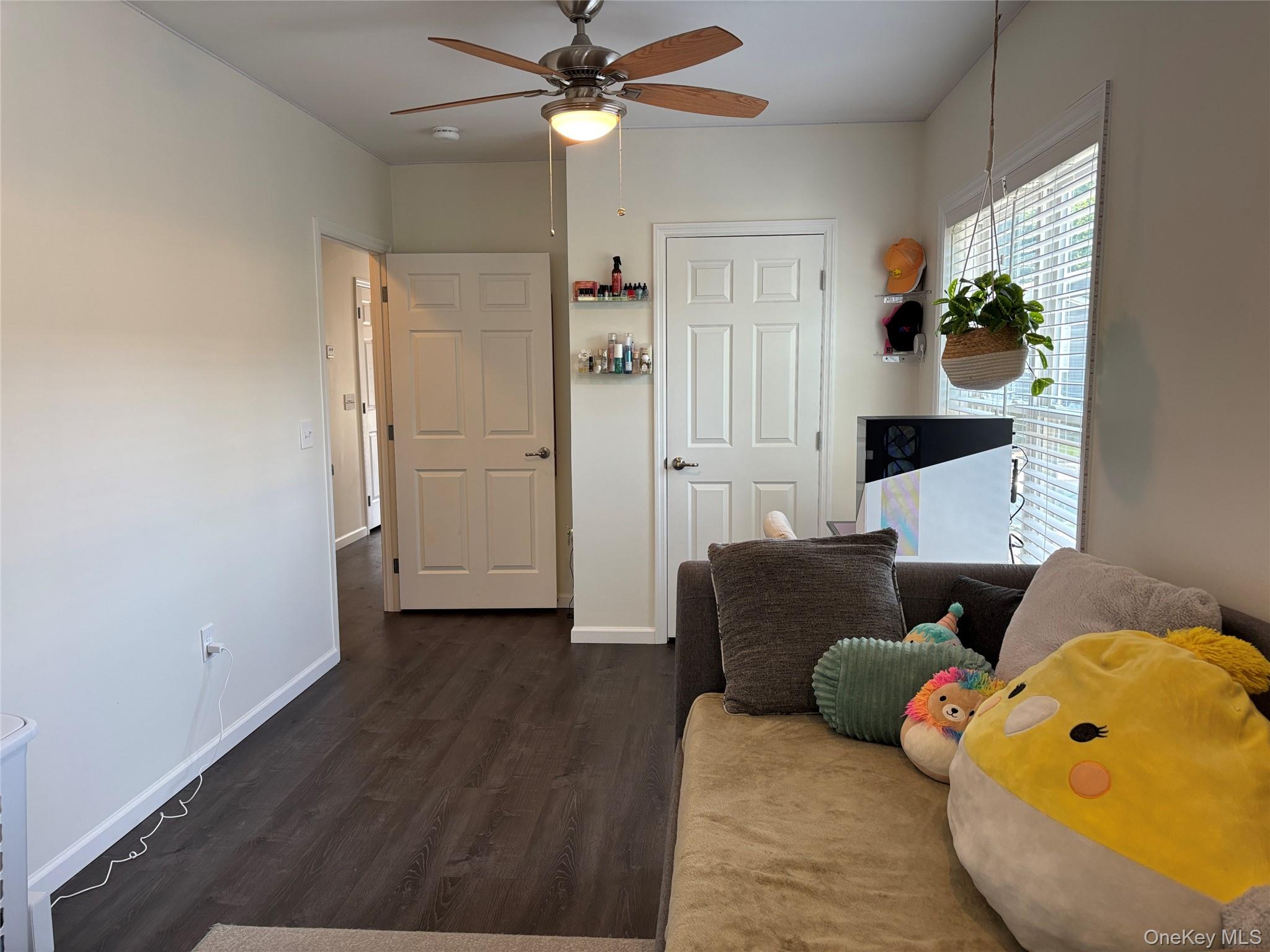 1661 Old Country Road, Unit 563 Riverhead, NY 11901 - Photo 23 of 43 a living room with furniture and wooden floor
