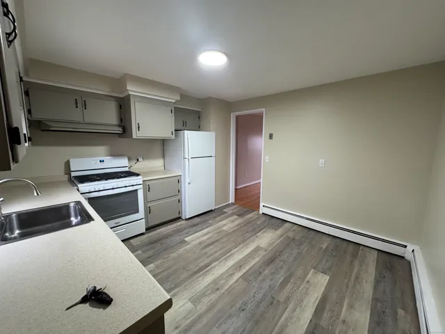 a kitchen with a refrigerator a stove and a sink