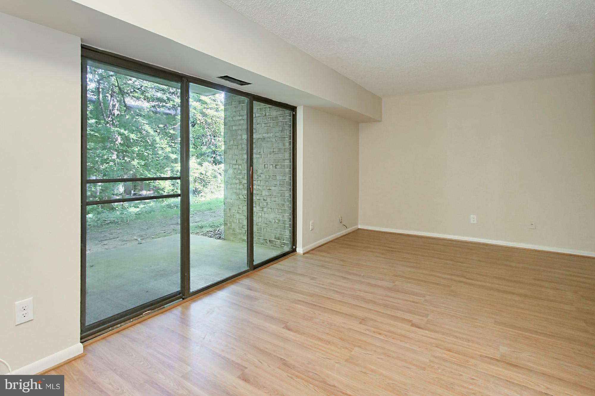 11625 Stoneview Square, Unit 2B Reston, VA 20191 - Photo 7 of 30 Living Room with Sliding Glass Door to Patio