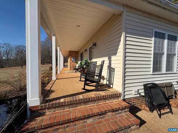 a room view with a balcony and patio